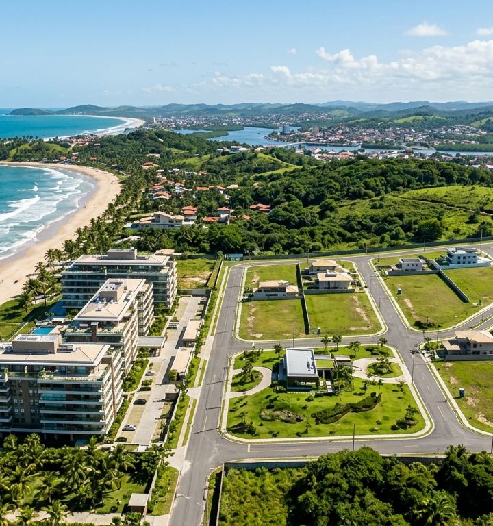 Vista aérea de Ilhéus mostrando opções de apartamentos e terrenos para investimento.